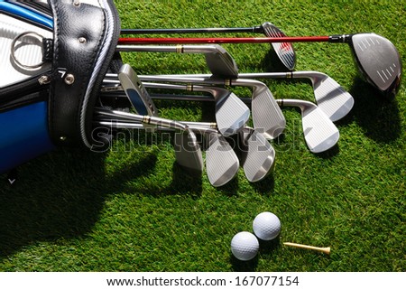 A shot of Golf balls,tee and clubs in the bag
