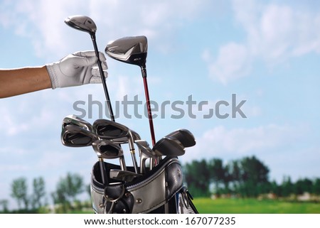 A shot of Removing golf club from bag