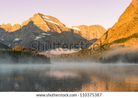 Dawn at Swiftcurrent Lake as viewed from the Many Glacier Hotel in Glacier National Park, Montana