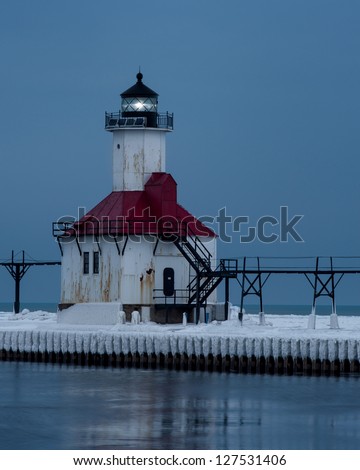 The St. Joseph North Pier Lighthouse illuminated in Winter in Saint Joseph, Michigan