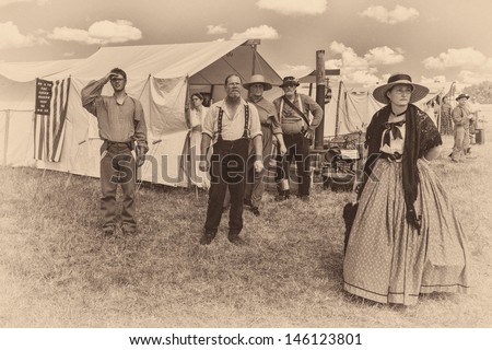 GETTYSBURG, PENNSYLVANIA - JULY 6, 2013: Reenactors watch as an injured person is lifted by helicopter from the field at the Civil War battles at Gettysburg on July 6, 2013 in Gettysburg, Pennsylvania