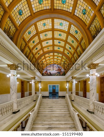 PIERRE, SOUTH DAKOTA - JULY 25: The grand staircase and stained glass ceiling in the rotunda of the South Dakota State Capitol on July 25, 2013 in Pierre, South Dakota