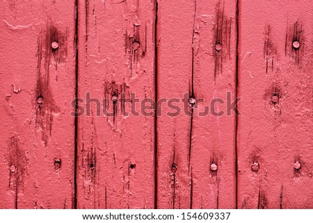 Nail heads in red wooden boards