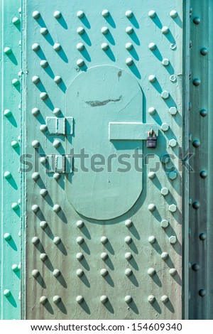 Turquoise access door panel on the St. Johns Bridge in Portland, Oregon