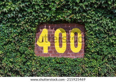 CHICAGO, ILLINOIS - SEPTEMBER 8: 400 feet sign on the outfield wall of Wrigley Field on September 8, 2014 in Chicago, Illinois
