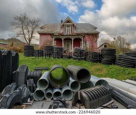 ROAN MOUNTAIN, TENNESSEE- OCTOBER 18: Rundown house with hoses in front yard on October 18, 2014 in Roan Mountain, Tennessee