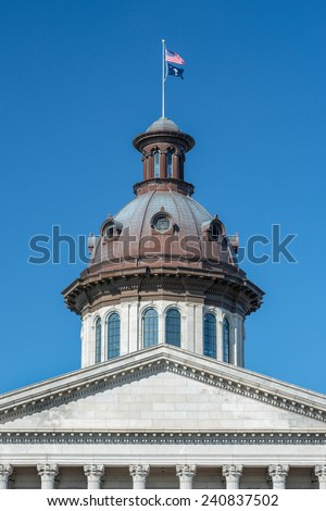 Flags fly over the dome of the South Carolina State House in Columbia, South Carolina