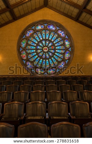HOLLAND, MICHIGAN - MAY 13: Stained glass rose window above choir seats in the Dimnent Memorial Chapel on the campus of Hope College on May 13, 2015 in Holland, Michigan