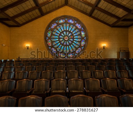 HOLLAND, MICHIGAN - MAY 13: Stained glass rose window above choir seats in the Dimnent Memorial Chapel on the campus of Hope College on May 13, 2015 in Holland, Michigan