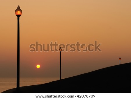 Lanterns by Water at Sunrise