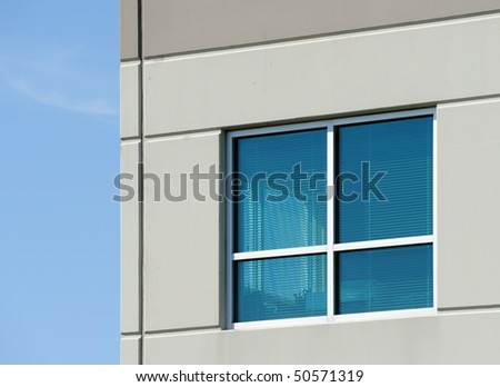 Office window with view through window to blue sky