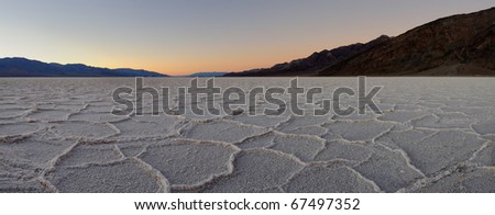Panoramic of sunset at the Badwater salt pan in Death Valley National Park, California