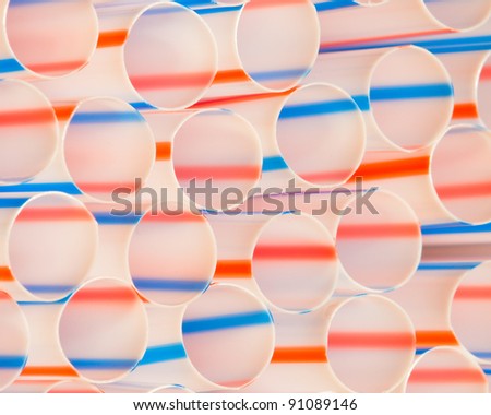 Red, white and blue straws form abstract pattern of ovals and lines