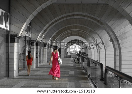 mother and daughter in red in a modern arches architecture alley