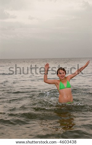 girl plays with water in sea