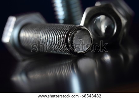 Bolt and nut on a black background.