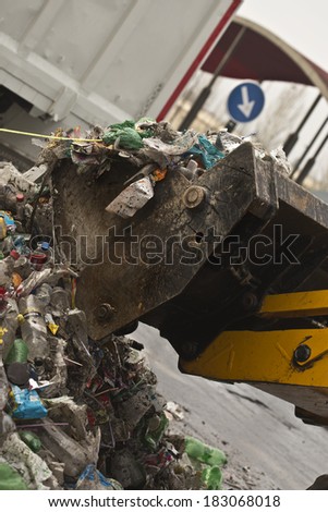 front-end loader picking up trash