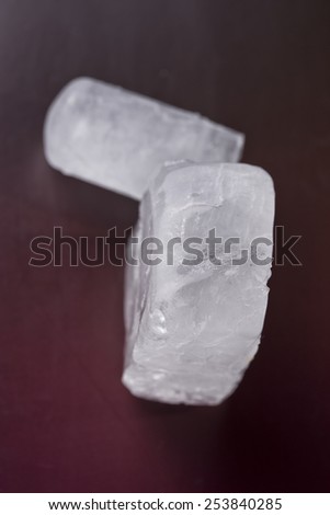 two ecologic deodorant crystal in dark red background