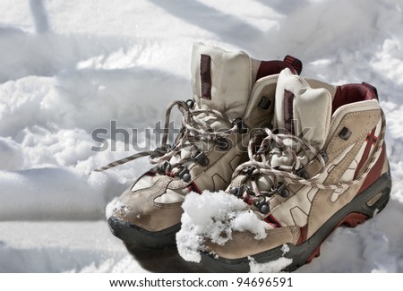 pairs of mountaineering boots on snow