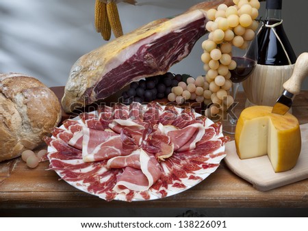 still life of ham, cheese and wine grapes