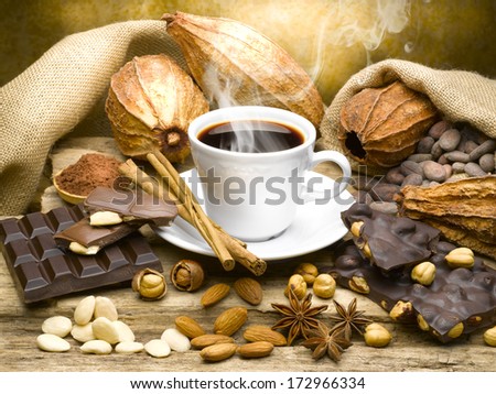Still life of cup of coffee with chocolate and cocoa