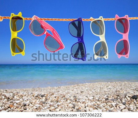 Collection of sunglasses on the beach