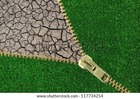 Global Warming. Zipper with cracked earth and grass