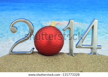 New year 2014 with Christmas ball on the beach
