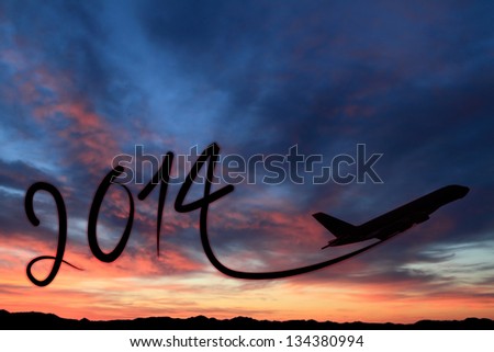 New year 2014 drawing by airplane on the air at sunset