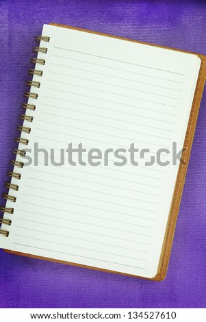White Blank notebook on purple background