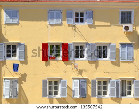 Stand out from the crowd - Being different concept, Red shutter among grey shutters