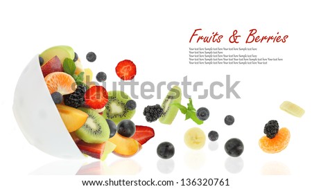 Fresh fruits coming out from a bowl Fresh fruits coming out from a bowl