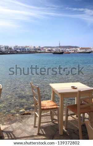 Coffee table at the sea shore. Mykonos island, Greece