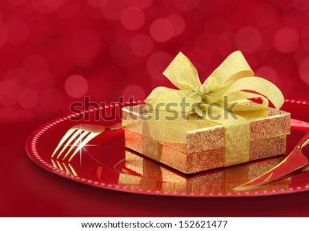 Festive table setting with gift box on a plate