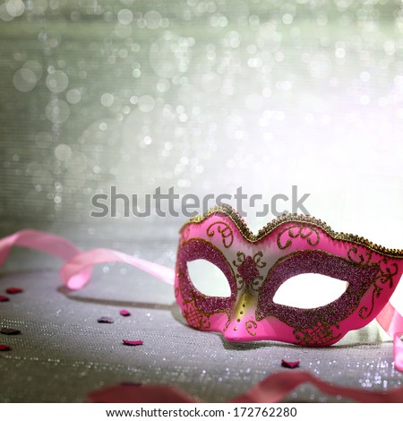 Pink carnival mask with glittering background
