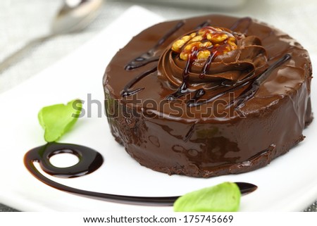 Chocolate dessert with decoration on white plate