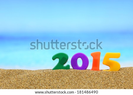 Multicolored new year 2015 on the beach