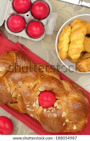 Easter sweet brioche with red eggs and vanilla cookies