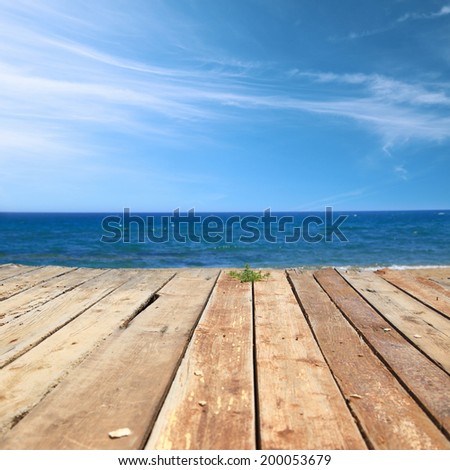 Wooden deck with sea and blue sky