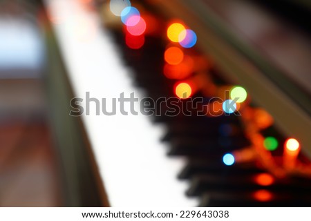 Abstract Christmas musical background with piano and lights.