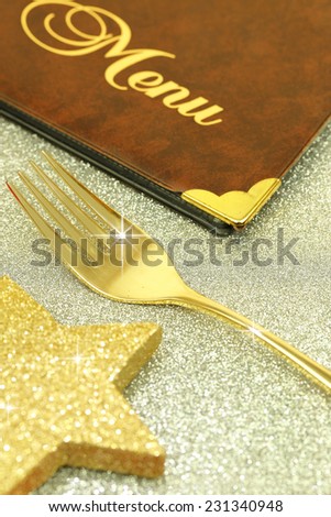 Golden fork and restaurant menu on festive background