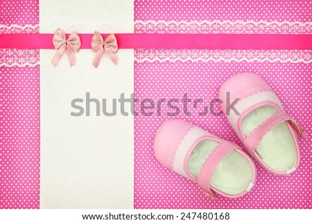 Baby shoes and blank banner on polka dots background