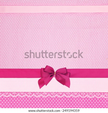 Pink retro polka dot textile background with ribbons and bow