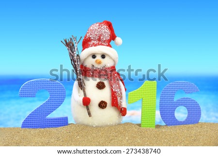 New year number 2016 and snowman on the beach