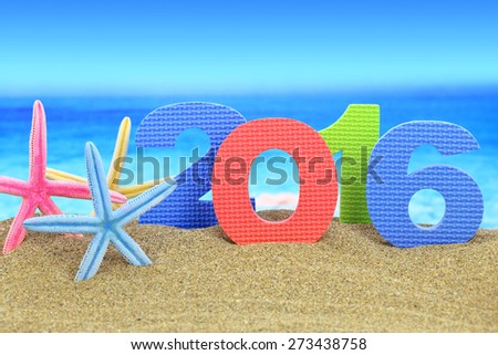 New year number 2016 and starfishes on the beach