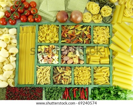 Pasta collection in wooden box and ingredients for cooking