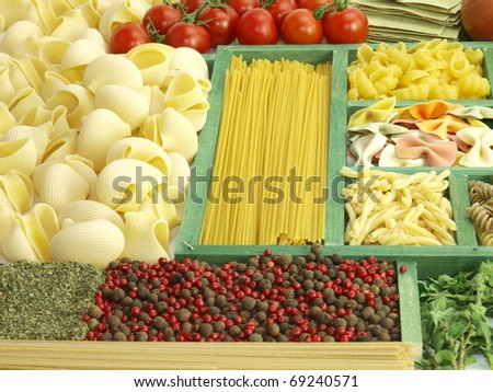 Pasta collection in wooden box and ingredients for cooking