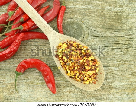 Chili pepper peppercorns and red chili peppers on wooden background