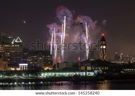 JERSEY CITY, NJ - JULY 4: The spectacular New York City Macy\'s July 4th fireworks display in the sky over the Hudson River viewed on July 4th, 2013 from the Jersey City, New Jersey.