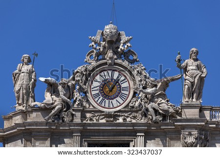 One of the giant clocks on the St. Peter\'s facade. Two clocks were added on both sides of the St. Peter\'s facade in 1786-1790 by Giuseppe Valadier.